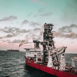 red and white ship on sea under cloudy sky during daytime